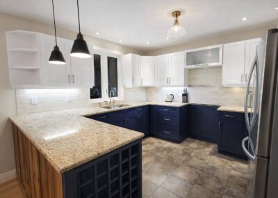 Cabinet Refacing in Prince Edward County. white uppers cabinets and blue lower cabinets in shaker style doors
