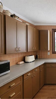 Outdated brown kitchen cabinets before cabinet refinishing