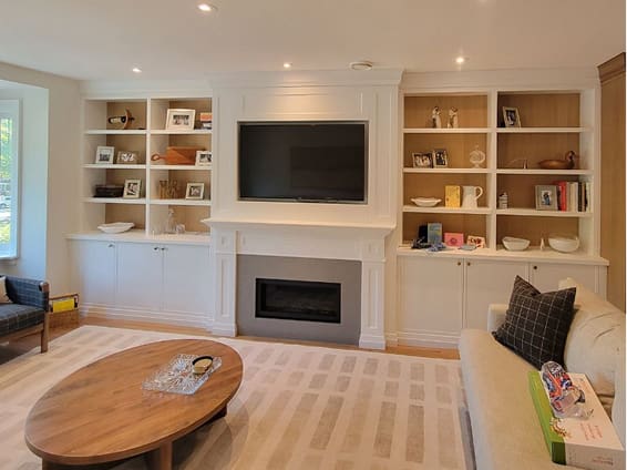 Custom built-in cabinets and shelving in a home office and living room