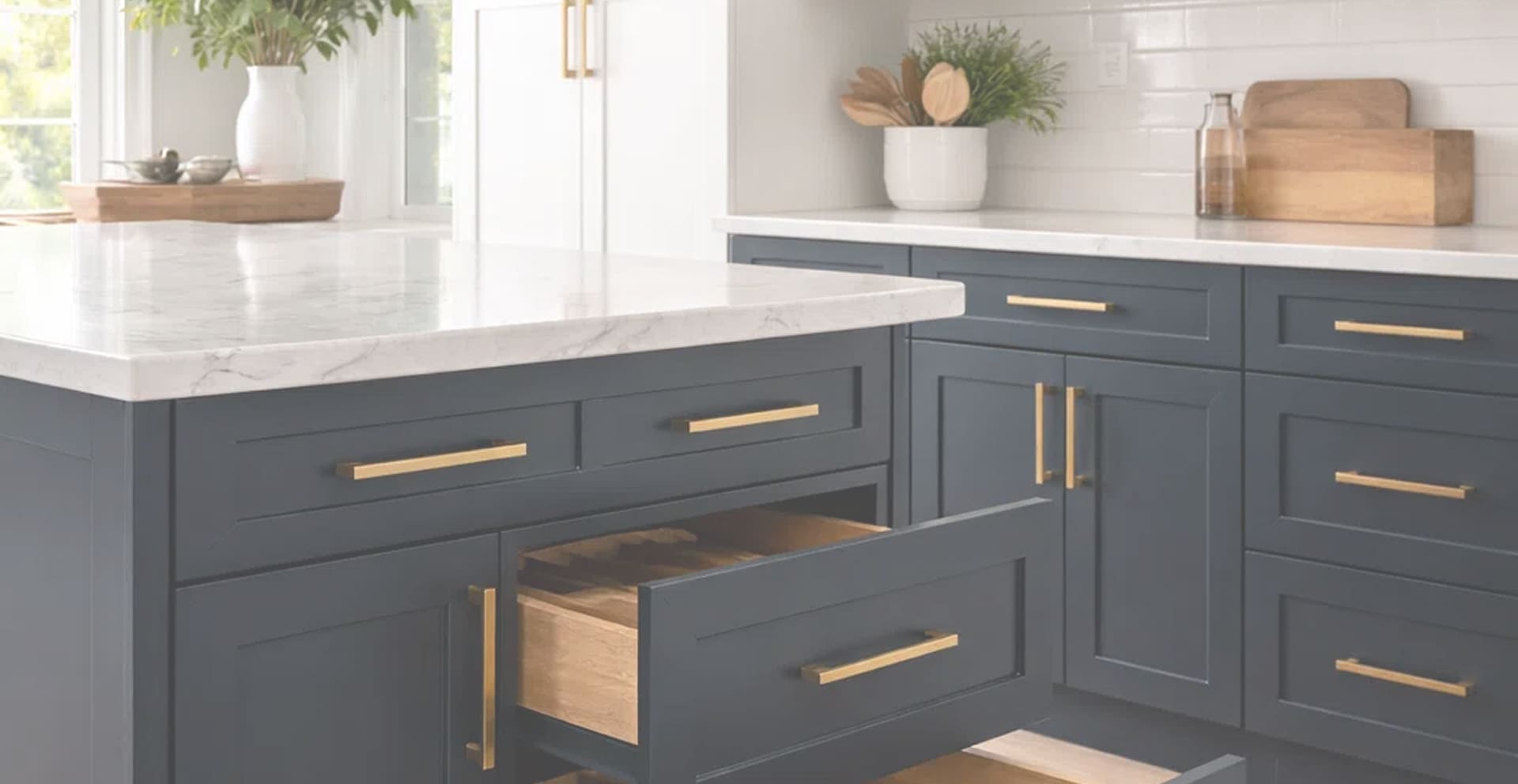 Navy blue kitchen cabinets with brass hardware after cabinet refacing by Rad Dezign