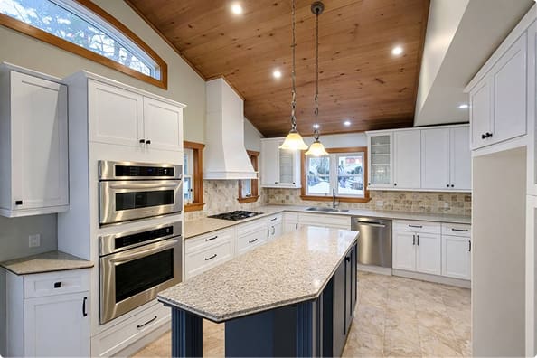 Kitchen with vaulted wood ceiling and white cabinets after cabinet refinishing