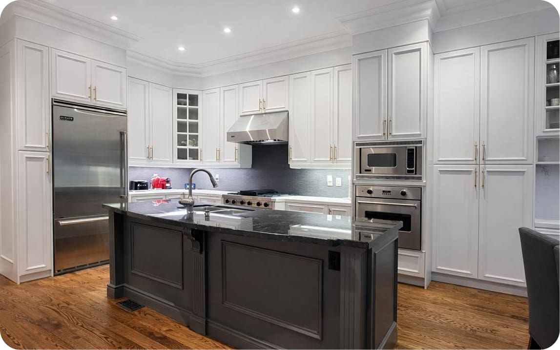 White kitchen with black island countertop after cabinet refinishing and refacing